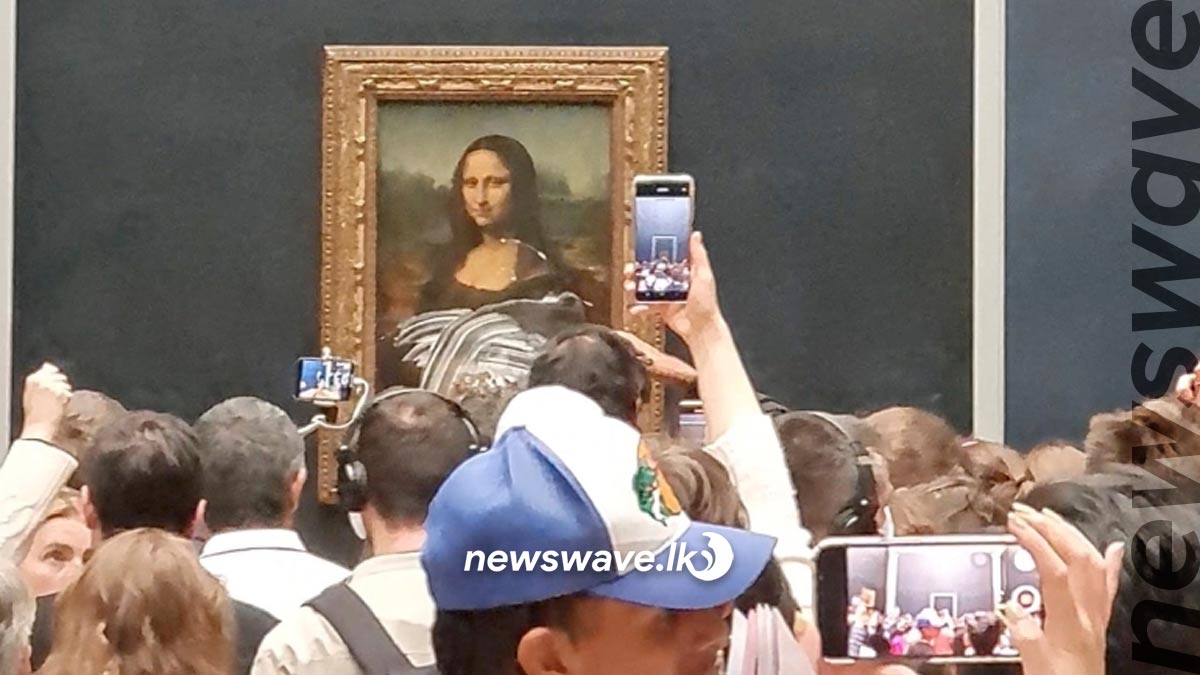 Nature activist hits Mona Lisa with a cake | NewsWave LK English